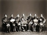 The women are not wearing Manchu style fashion and so are Han Chinese. They may be entertainers from the southern province of Guangdong.